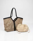 Woven bag with black trim and a beige drawstring pouch on a white background