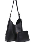 Black leather handbag with matching pouch on a white background