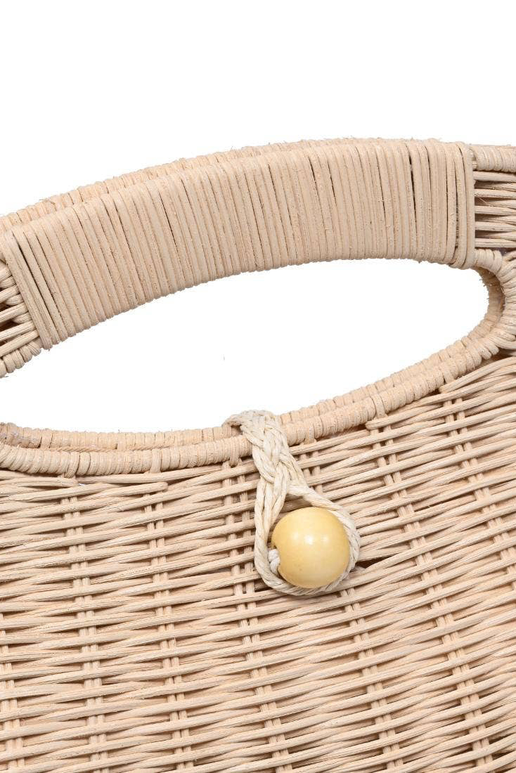 Close-up of a woven handbag handle with a wooden ball accent on a white background