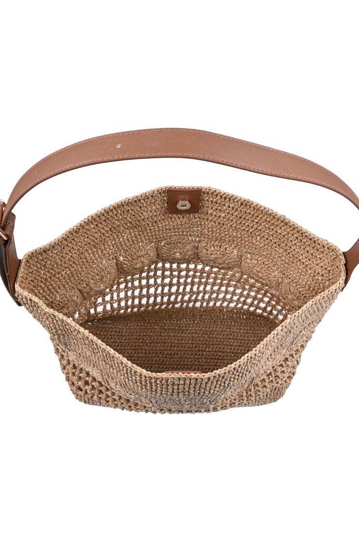 Woven basket with a brown handle on a white background