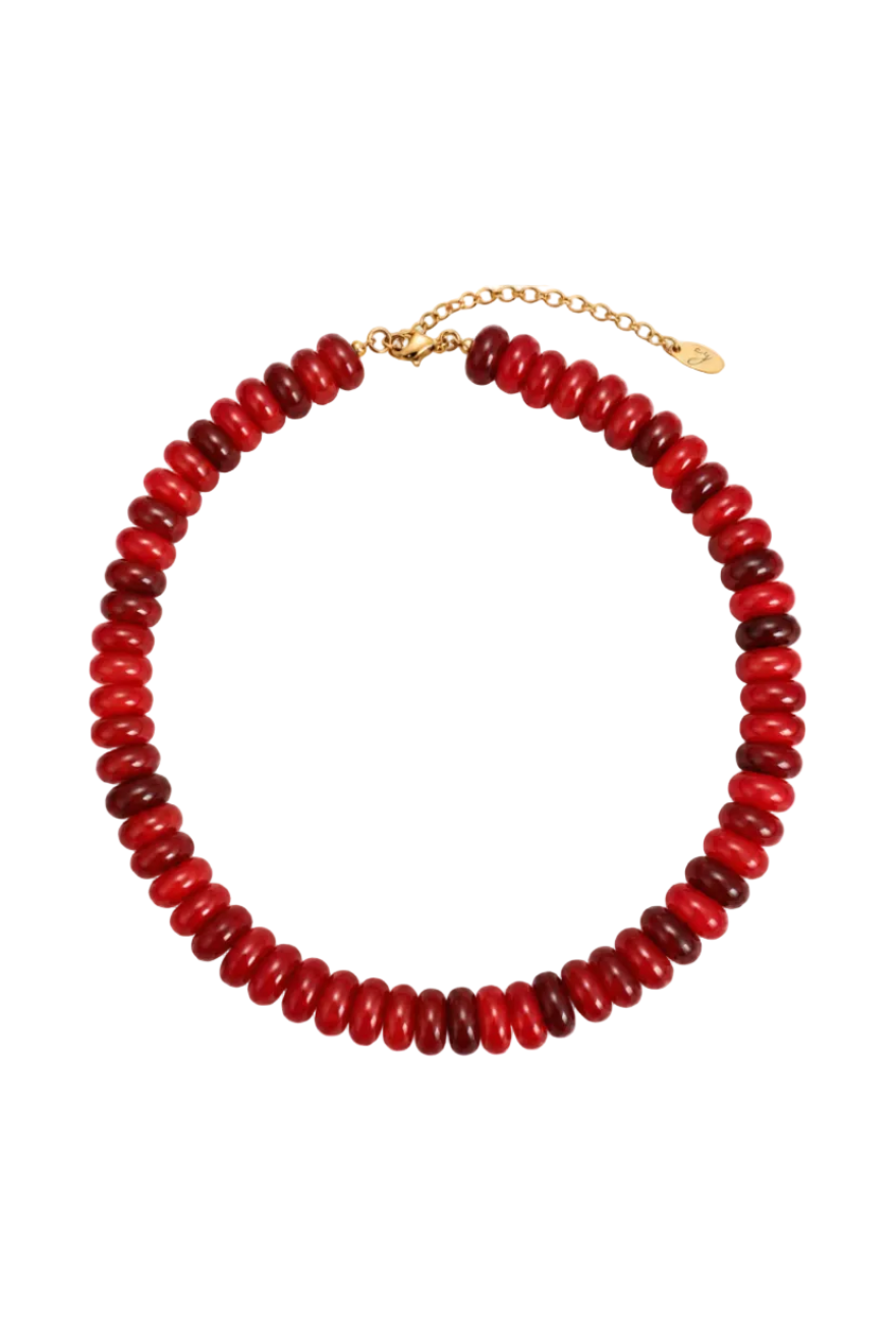 A beaded collar necklace made of alternating glossy red and deep burgundy beads, finished with a gold-tone lobster clasp and extender chain.
