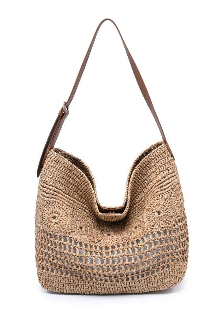 Woven handbag with a brown strap on a white background