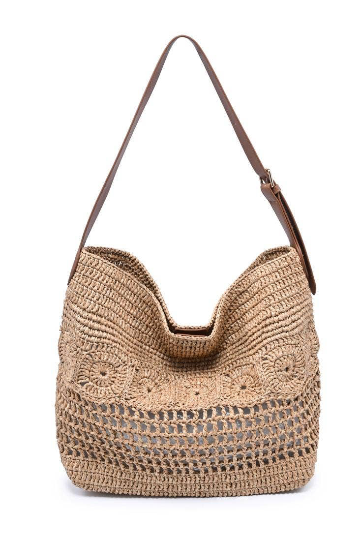 Woven handbag with a brown strap on a white background