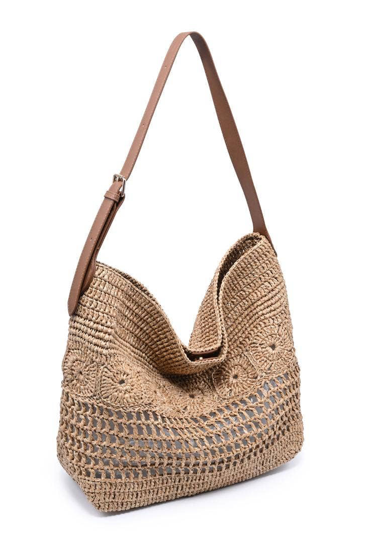 Woven handbag with a brown strap on a white background