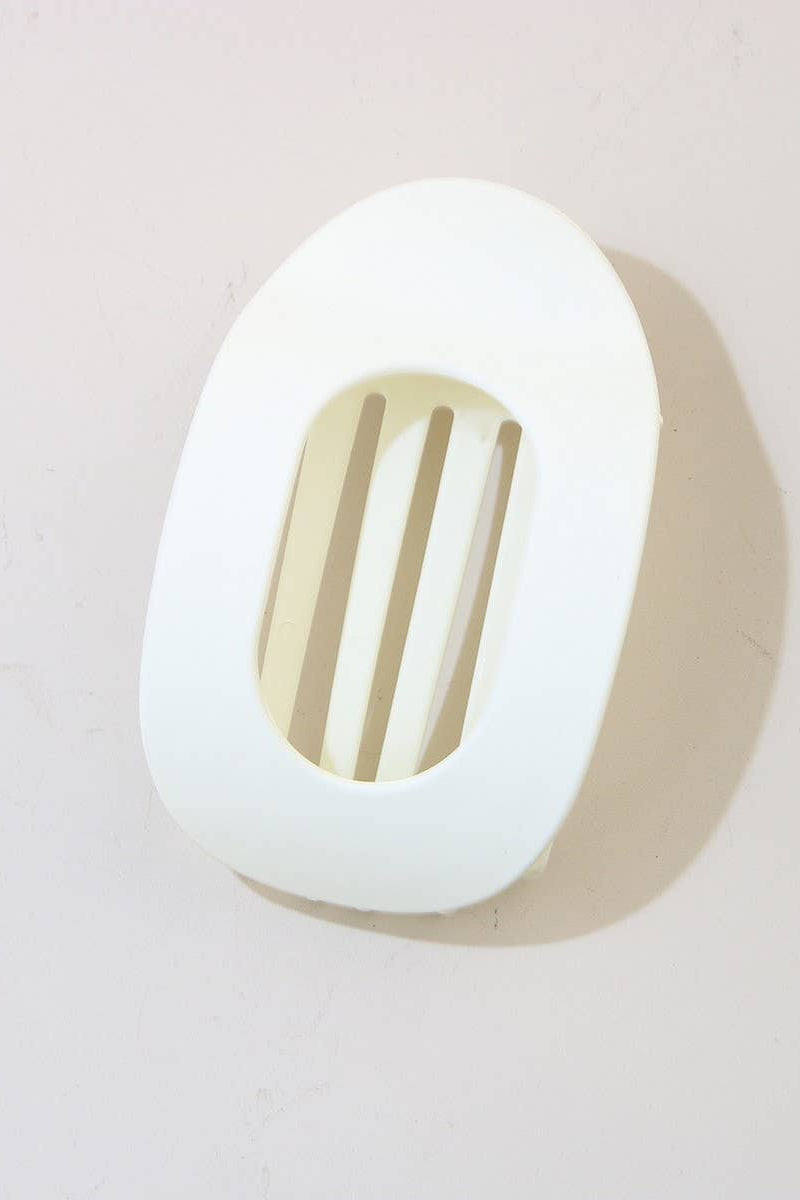 White wall light fixture with a gold grille on a light gray background