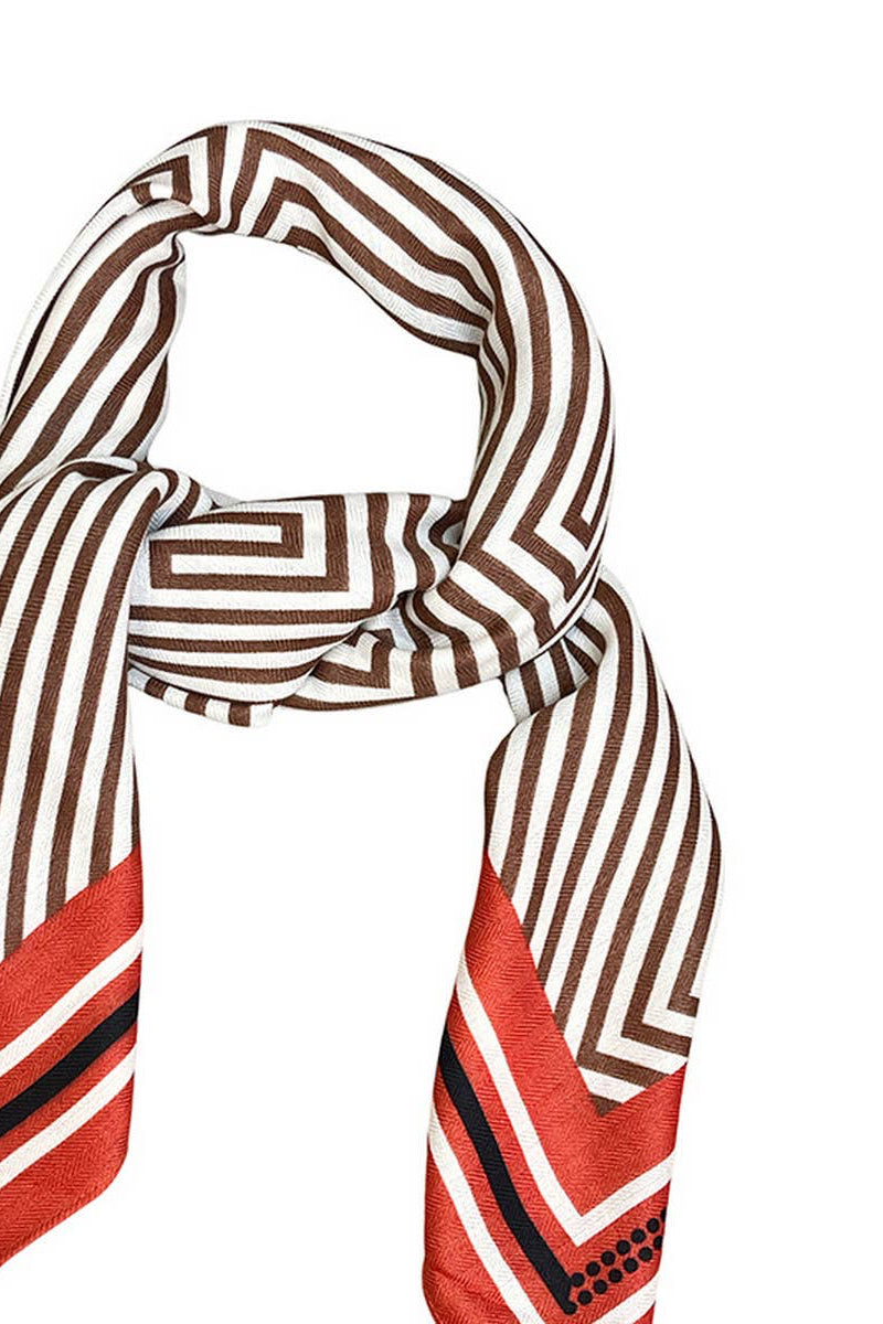 A patterned silk scarf with brown and white geometric stripes and red chevron ends, styled in a loop on a plain white background.