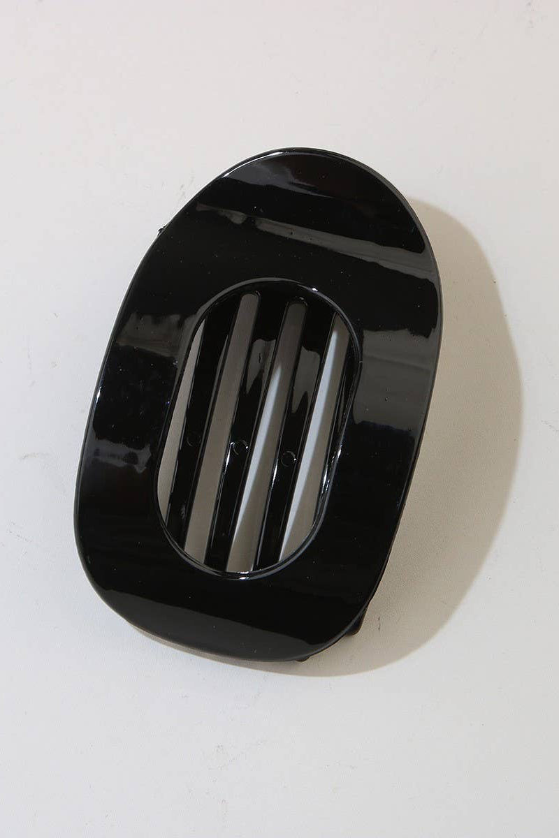 Black rectangular object with slits on a white background