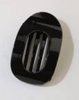 Black rectangular object with slits on a white background