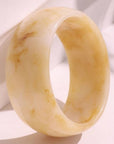 Beige stone ring on a light fabric background