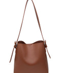 Brown leather handbag with a strap on a white background