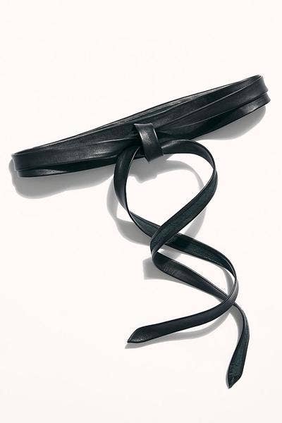 Black leather belt with a decorative knot on a white background