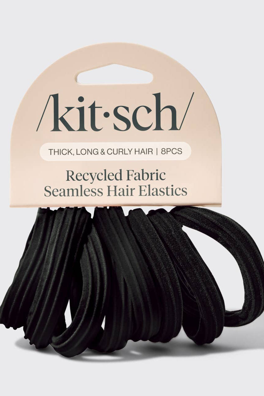 A pack of black seamless hair elastics by kit·sch, packaged on a beige cardboard header card that reads 'Thick, Long & Curly Hair | 8PCS' and 'Recycled Fabric Seamless Hair Elastics.'.