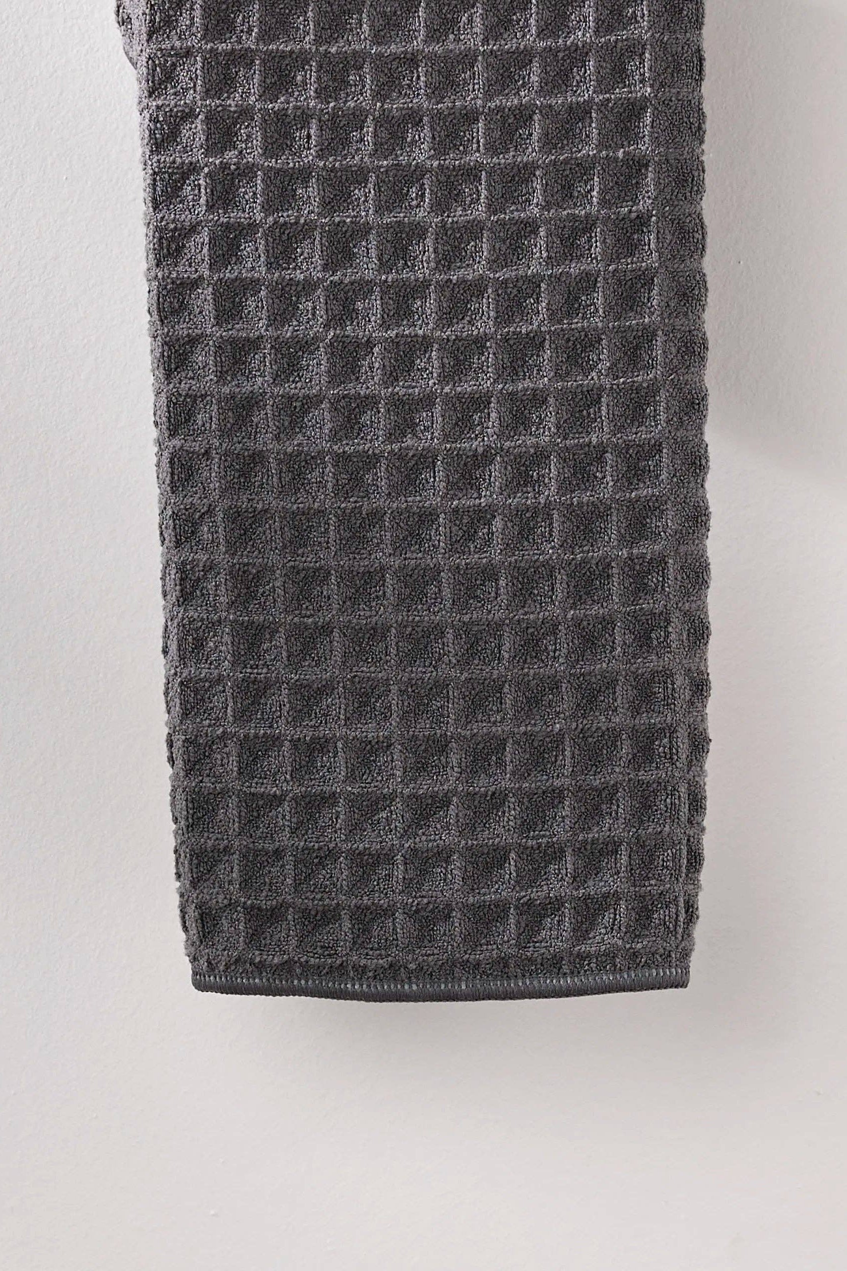 Gray textured towel on a light gray background