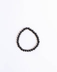 Black beaded bracelet on a white background