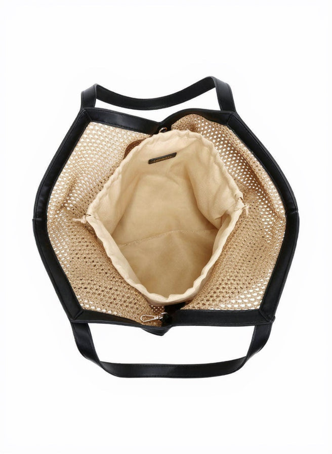 Straw bag with black handles on a white background