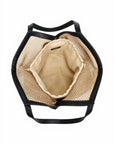 Straw bag with black handles on a white background