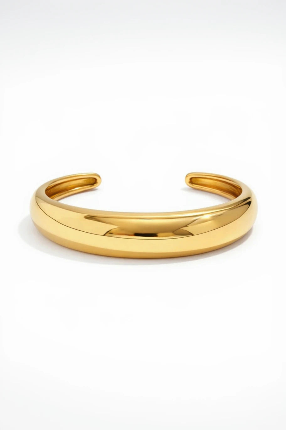 Gold bangle on a white background
