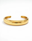 Gold bangle on a white background