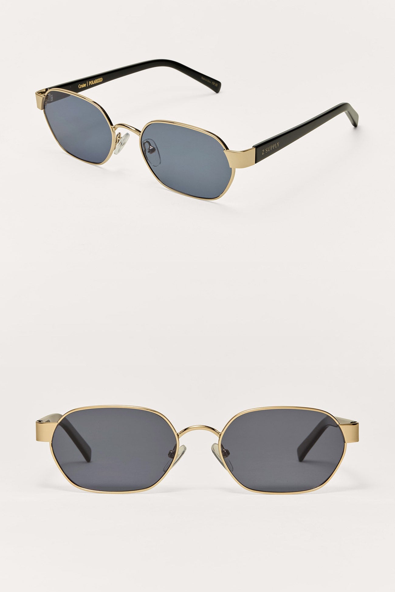 Pair of sunglasses with gold frames and black lenses on a white background