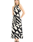 Woman wearing a black and white patterned dress on a white background