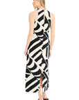 Woman wearing a black and white patterned halter neck dress on a white background