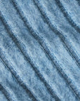 Close-up of textured blue fabric with a ribbed pattern