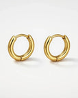 Gold hoop earrings on a white background