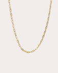 Gold chain necklace on a light beige background