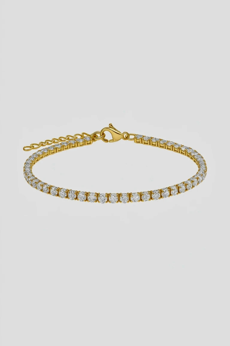 Gold bracelet with clear gemstones on a white background