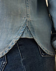 Close-up of a blue denim shirt with a blurred background