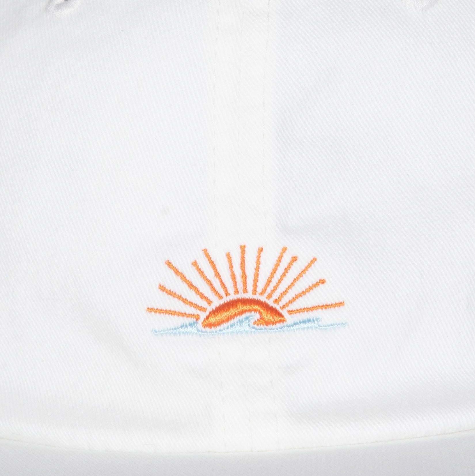 Embroidered sun design on a white background