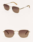 Gold-framed sunglasses with brown lenses on a white background