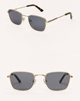 Gold-framed sunglasses with dark lenses on a white background