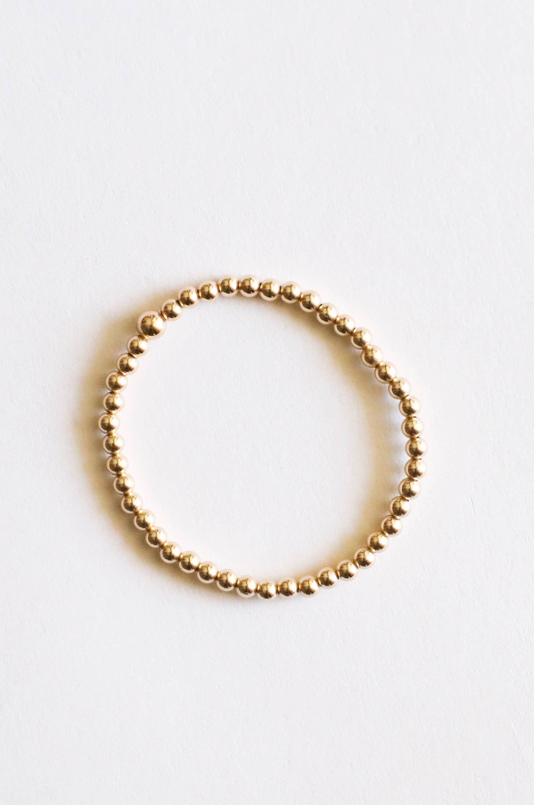 Gold beaded ring on a white background