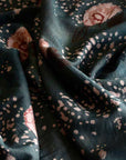 Dark green fabric with pink floral patterns