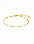 Gold chain bracelet on a white background