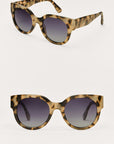 Pair of tortoiseshell sunglasses with gradient lenses on a light gray background
