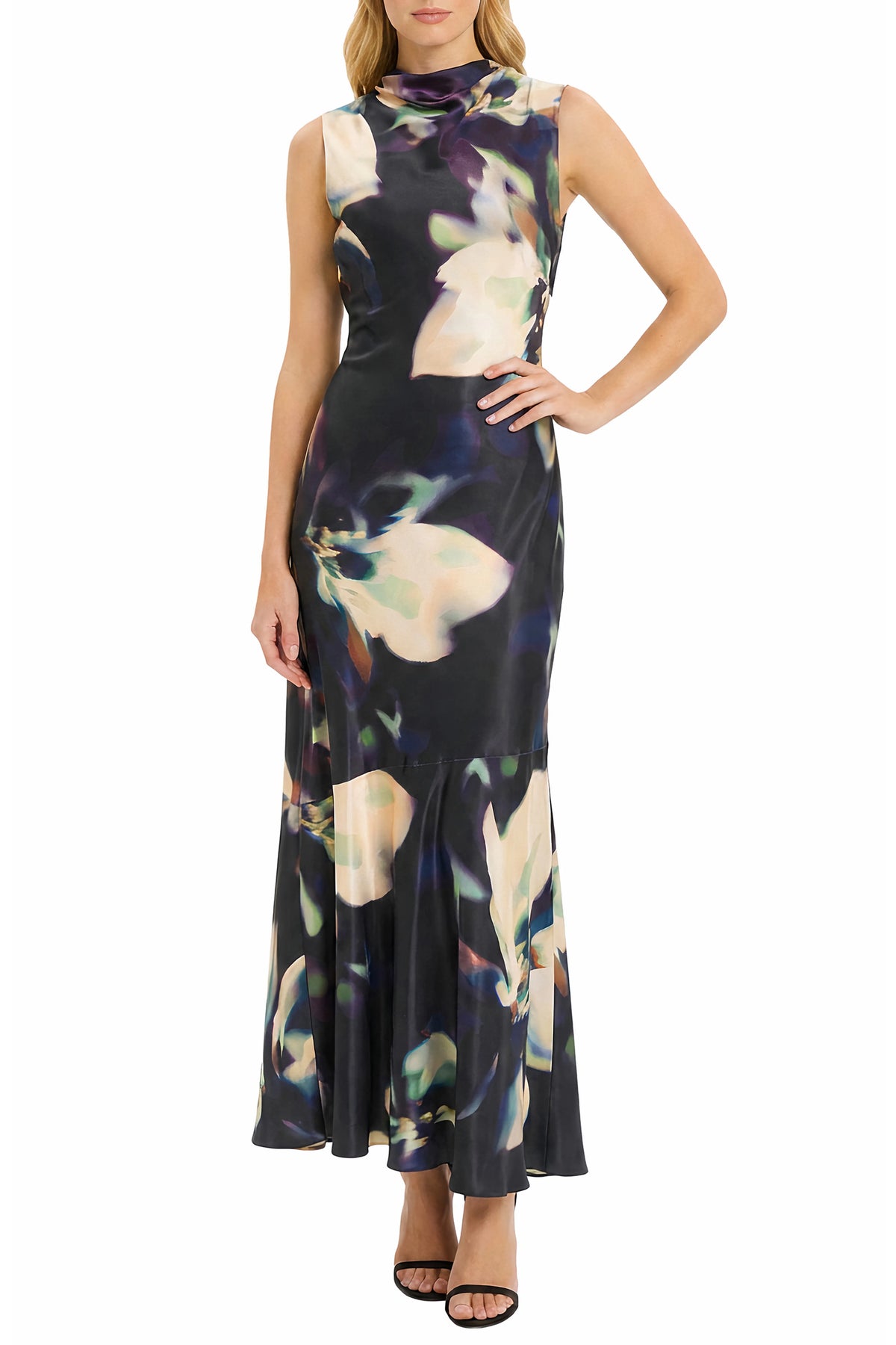 A sleeveless high-neck maxi dress with a dark navy and black base, featuring a large abstract floral print in cream, beige, and purple, modeled against a plain white background.