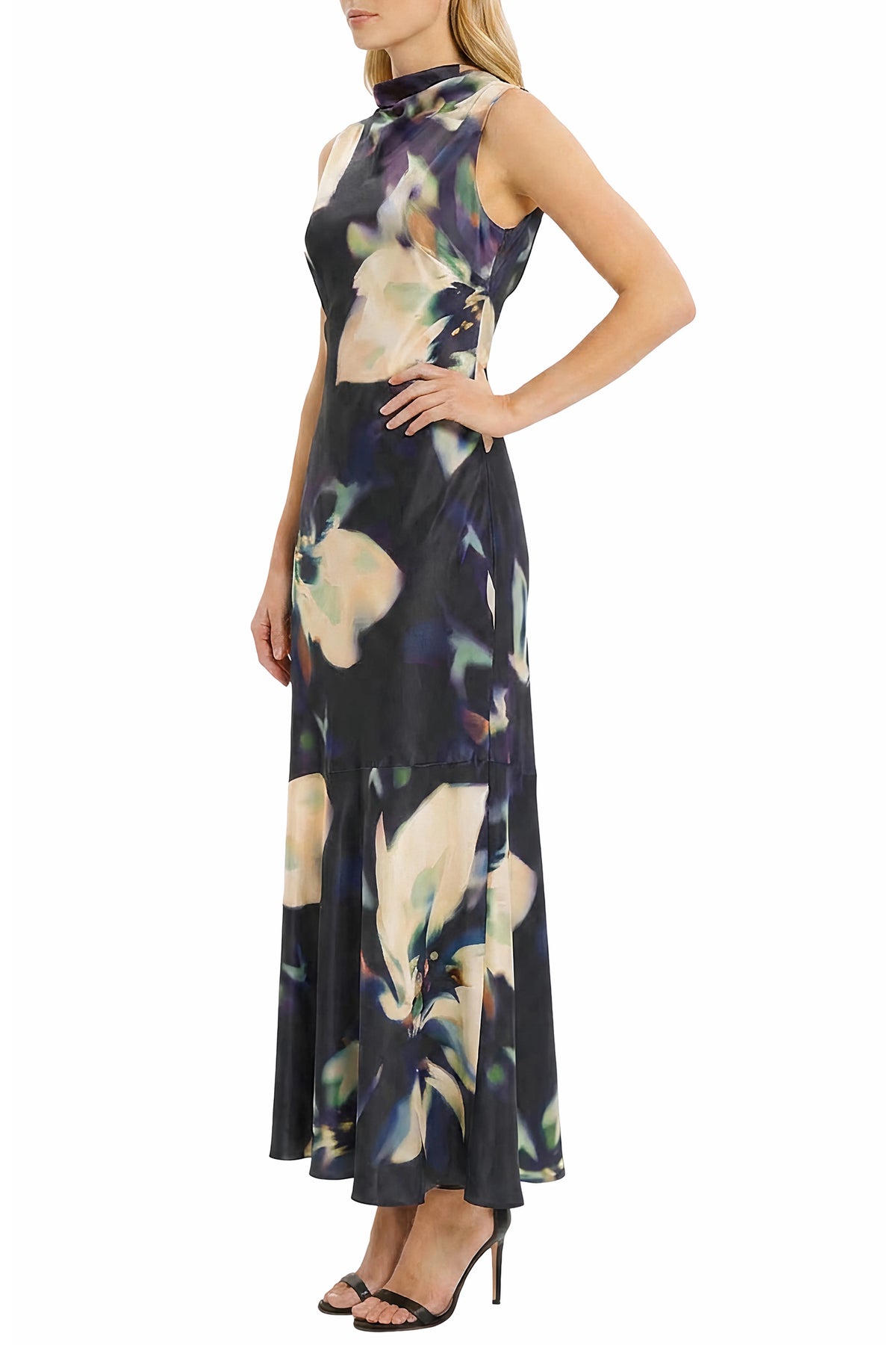 A sleeveless high-neck maxi dress with a dark navy base and a large abstract floral print in cream, beige, and purple, modeled against a plain white background.