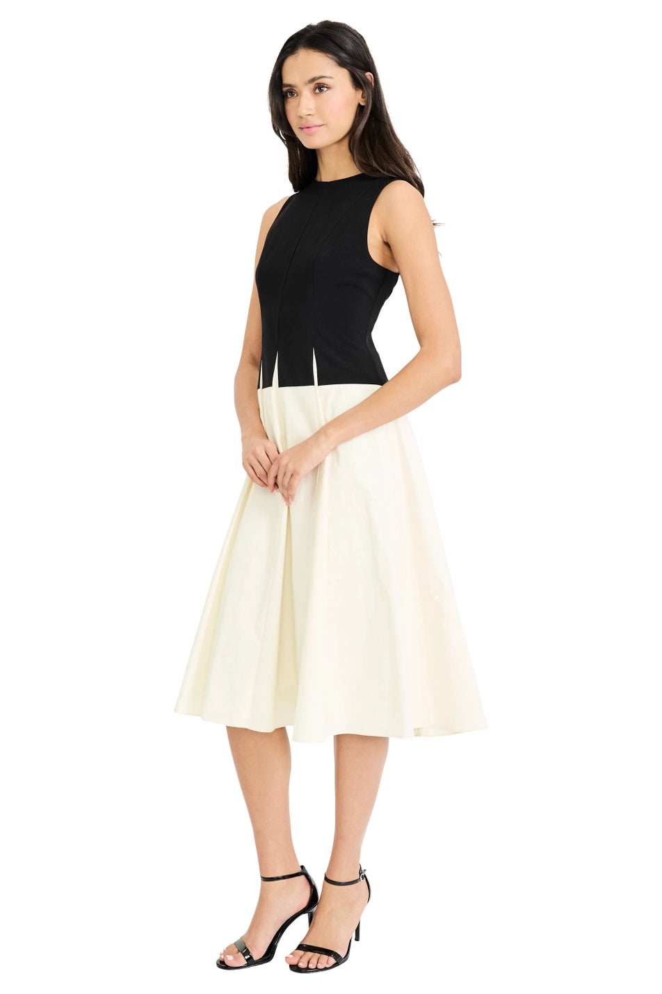 Woman wearing a black top and white skirt on a white background