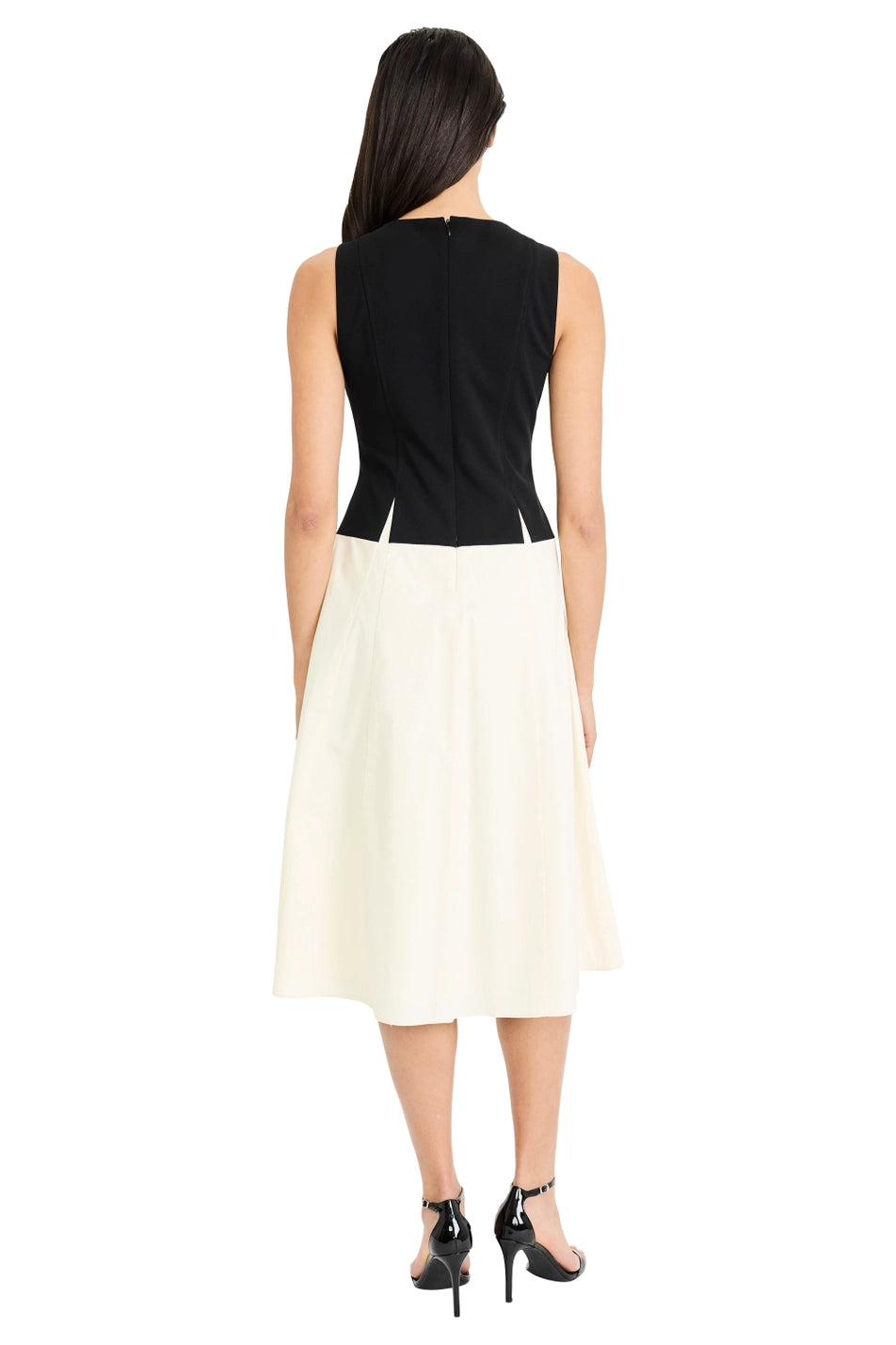 Woman wearing a black top and white skirt on a white background