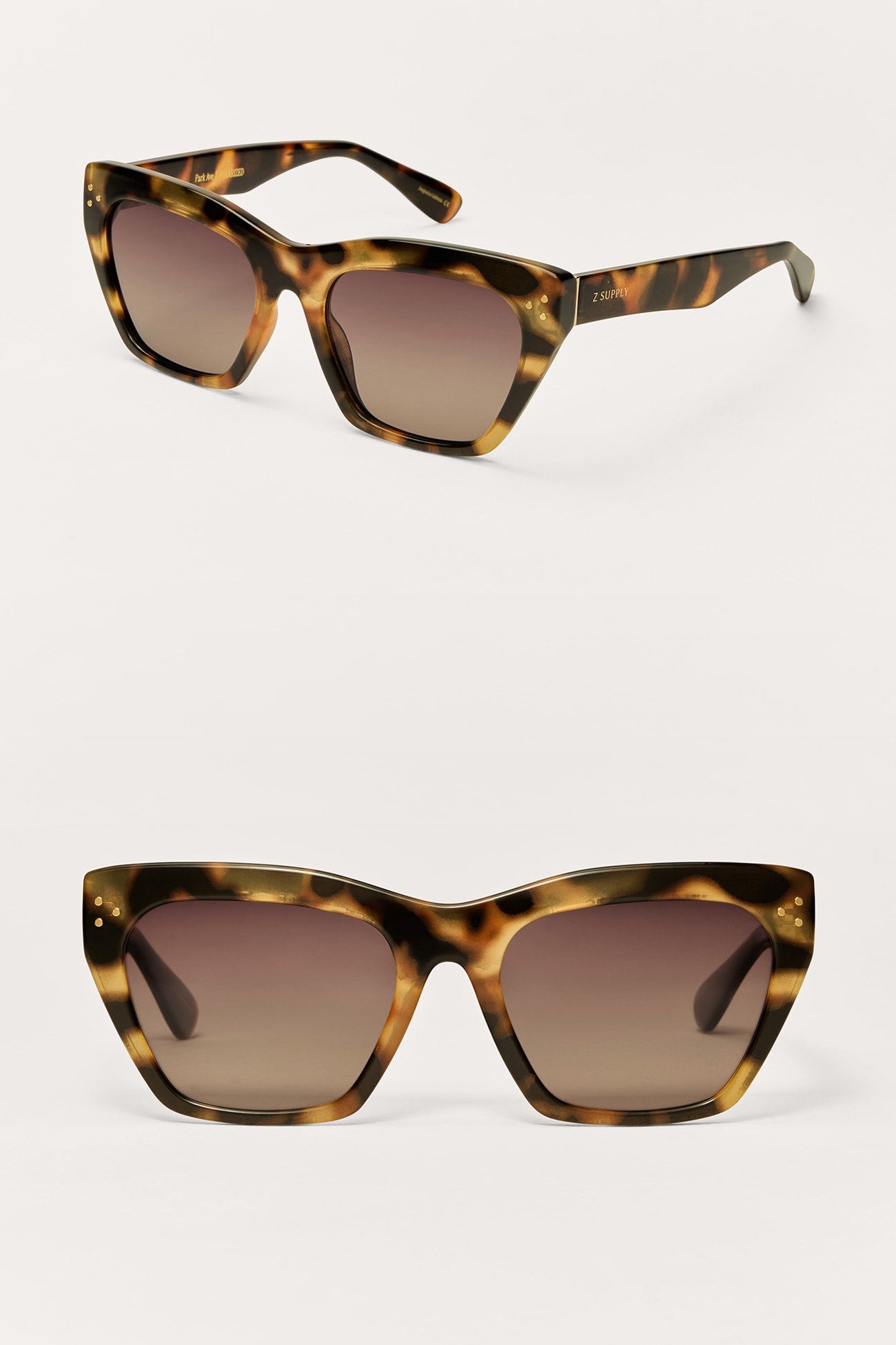 Tortoiseshell sunglasses with brown gradient lenses on a white background