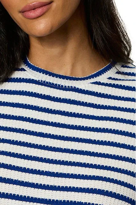 Close-up of a person wearing a blue and white striped shirt.