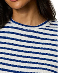 Close-up of a person wearing a blue and white striped shirt.