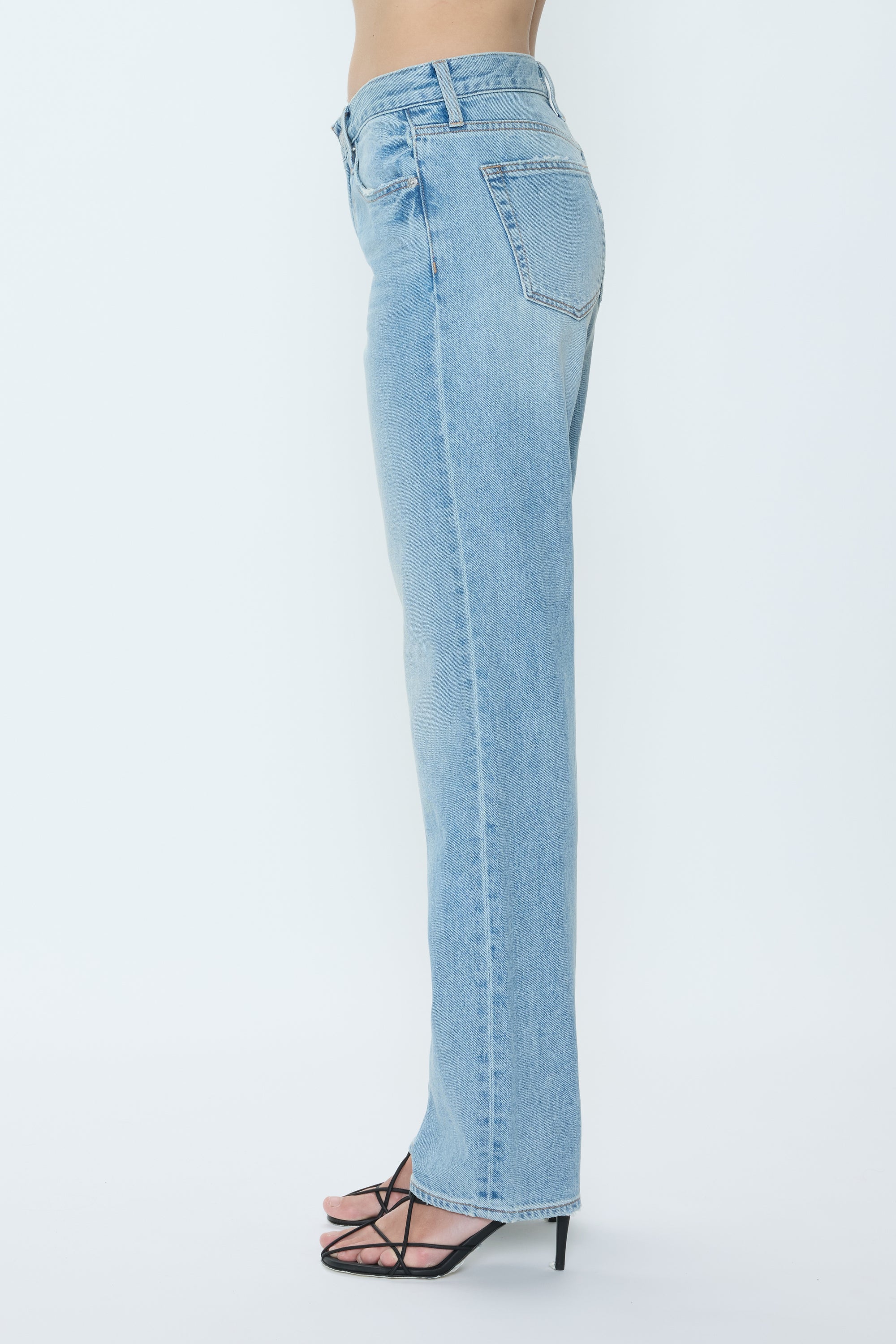 Light blue jeans worn by a person on a white background