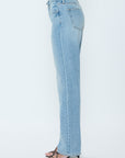 Light blue jeans worn by a person on a white background