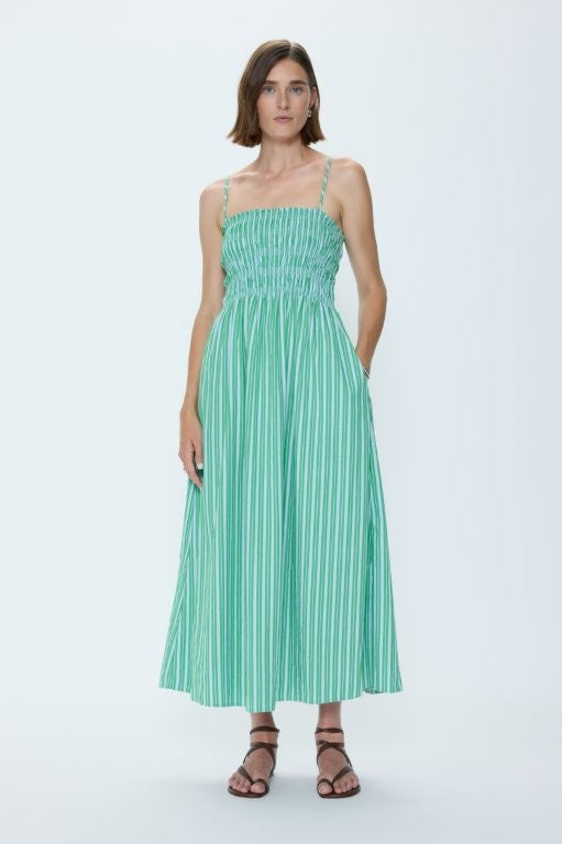 Woman wearing a green striped dress on a white background