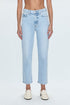 A pair of high-waisted, straight leg blue jeans with a cropped hem, paired with white shoes.