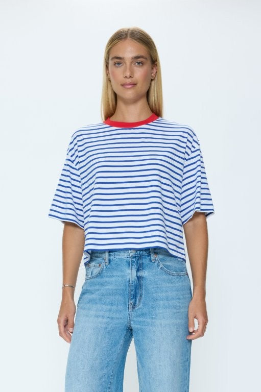 Woman wearing a striped shirt and jeans on a white background