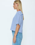Person wearing a blue and white striped shirt and light blue jeans on a white background
